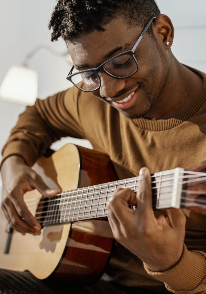 front-view-smiley-male-musician-home-playing-guitar-bed-scaled-quxl0o963wgsiwebad0iknhol1w54myes3m6z8w3rk.jpg